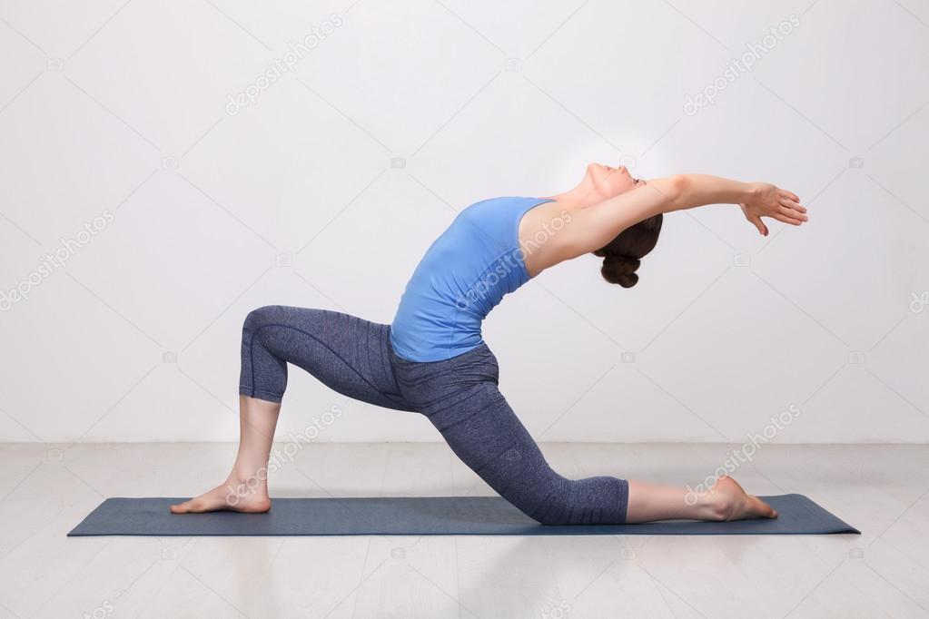 Fit yogini woman practices yoga asana  Anjaneyasana