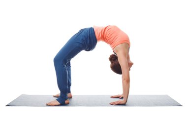 Beautiful sporty fit yogi girl practices yoga asana chakrasana