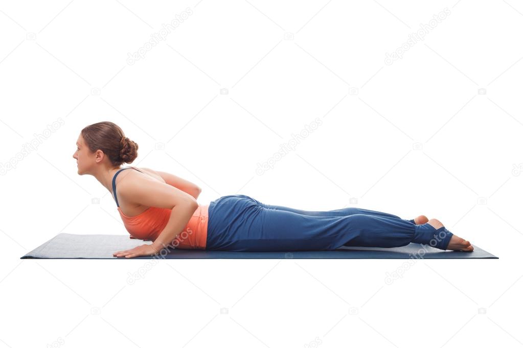 Sporty fit yogini woman practices yoga asana bhujangasana 