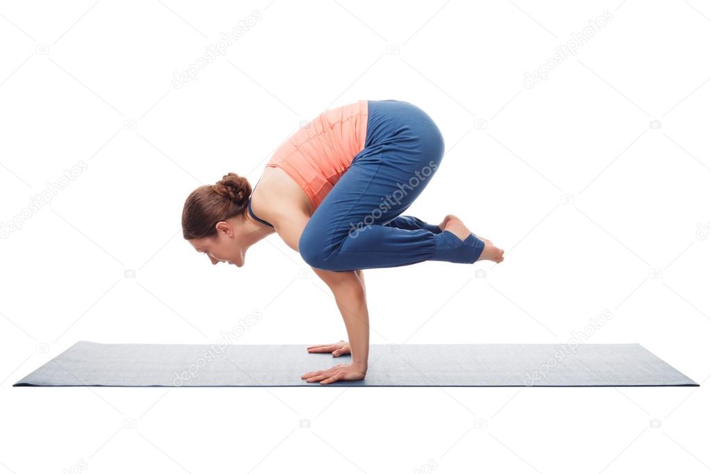 Beautiful sporty fit yogini woman practices yoga asana kakasana