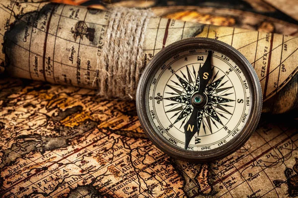 Old vintage compass on ancient map