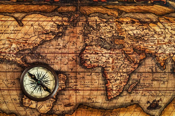 Old vintage compass on ancient map — Stock Photo, Image