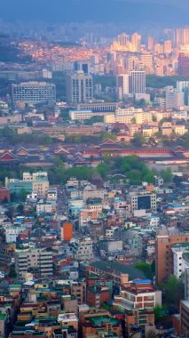 Seul şehir merkezi ve Inwang Dağı 'ndan gün batımı manzaralı Gyeongbokgung Sarayı. Seul, Güney Kore. Kamera tavası