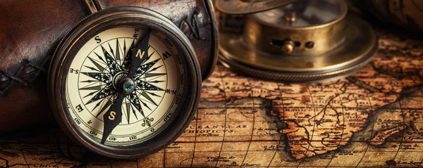 Old vintage compass on ancient map — Stock Photo, Image