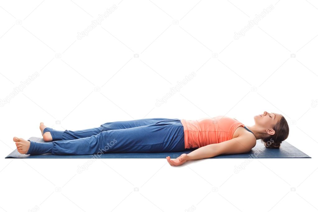 Sporty fit yogi girl relax in yoga asana Savasana