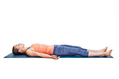 Sporty woman relaxes in yoga asana Savasana clipart