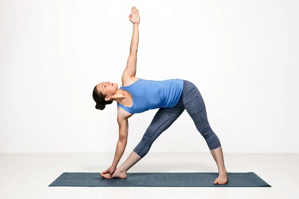 女人做法瑜伽体式伸展三角式 — 图库照片