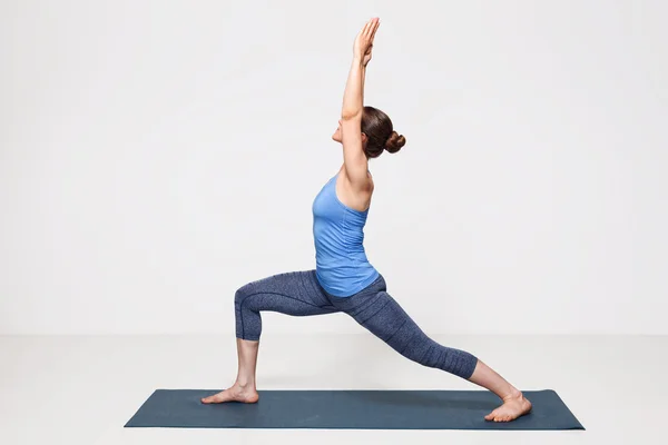 stock image Woman practices yoga asana utthita Virabhadrasana