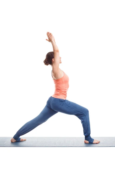 Woman practices yoga asana utthita Virabhadrasana — Stock Photo, Image