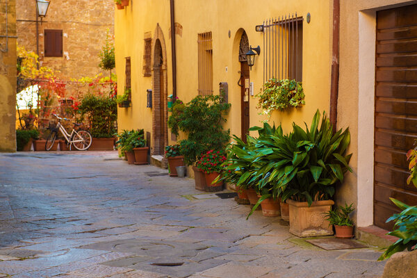 View of the ancient old european city. Street of Pienza, Italy. Sunny travel vintage background with copy space.