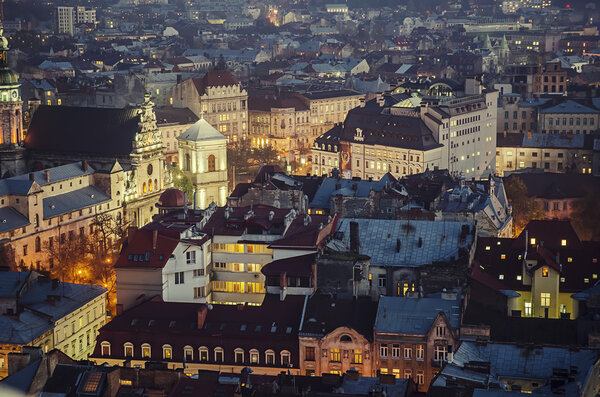 Night view of western european city Lviv, architecture background in vintage hipster style