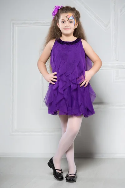 Young girl posing in purple dress — Stock Photo, Image