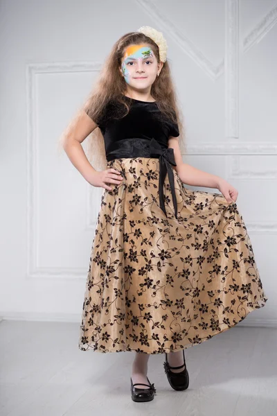 Young girl posing in black and beige dress — Stock Photo, Image