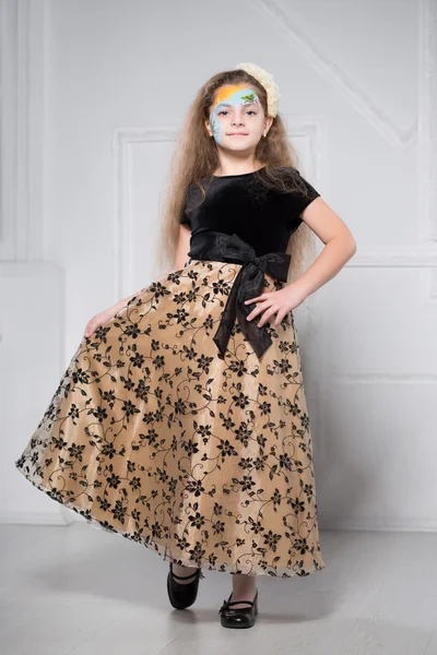 Young girl posing in black and beige dress — Stock Photo, Image