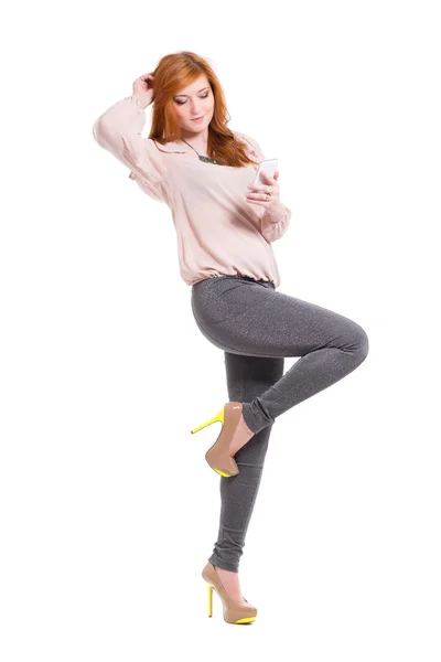 Redhead woman posing with smartphone — Stock Photo, Image