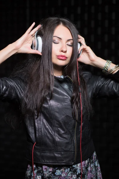 Woman posing with headphones and closed eyes. — Stock Photo, Image