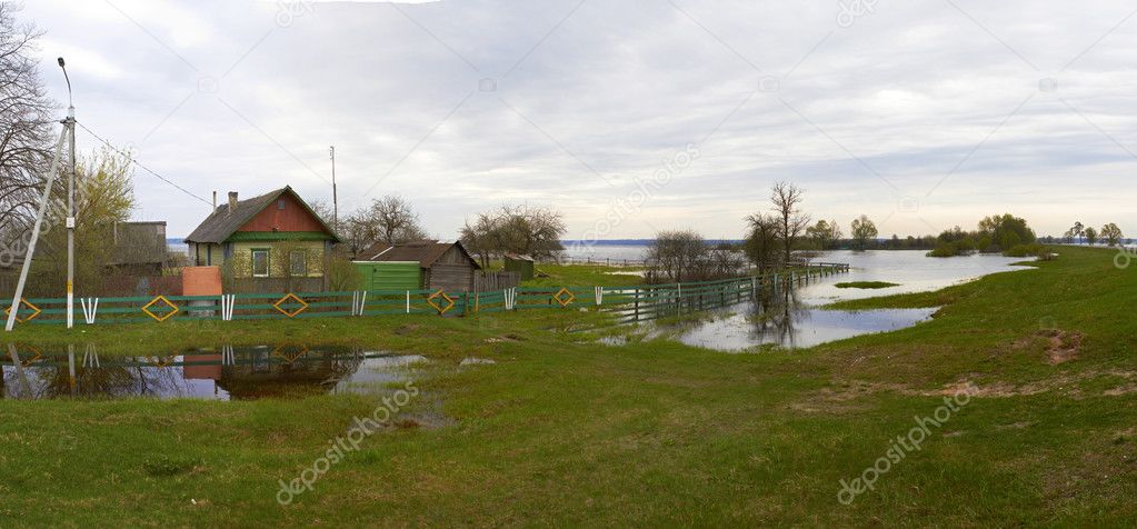 Spring panorama with the river in flood cloudy day