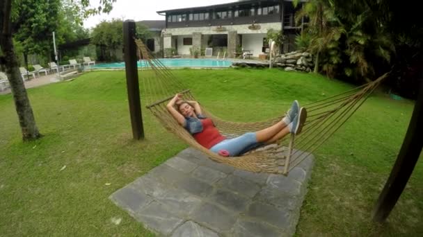 Young woman lying in a hammock — Stock Video