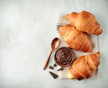 Classic croissants with chocolate topping on concrete table. Top view  croissants. Breakfast.