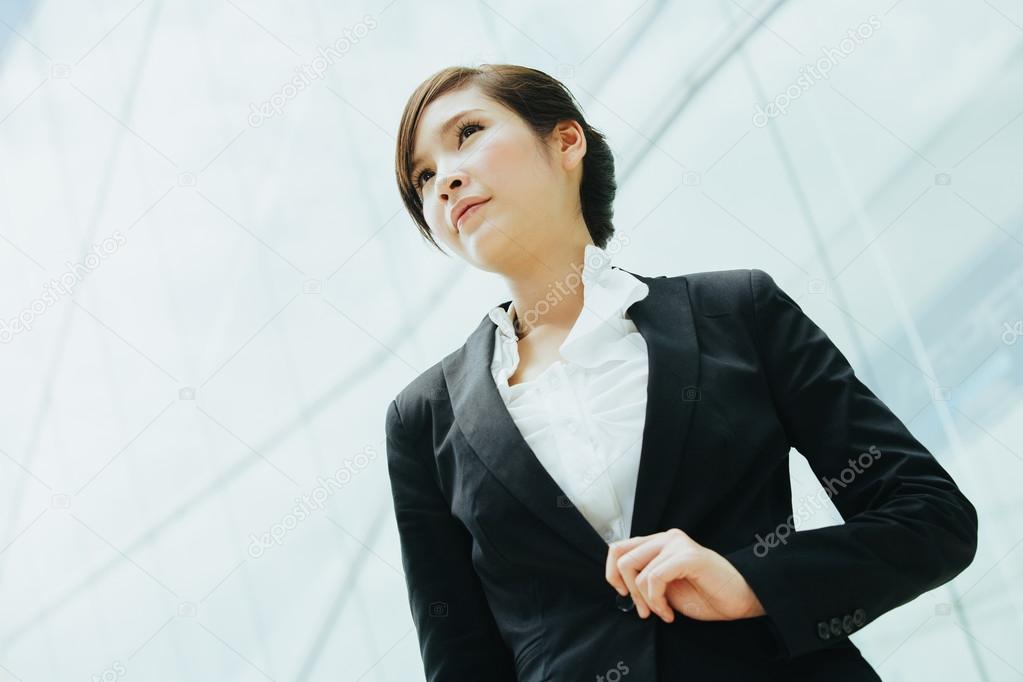 Asian businesswoman in front of glass wall