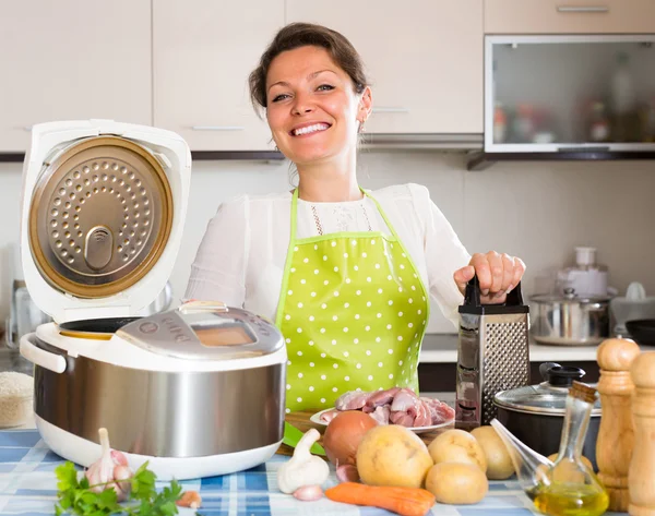Housewife cooking with multicooker — Stock Photo, Image
