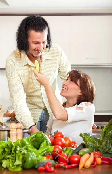 Housewife with man cooking with vegetables — Stock Photo, Image