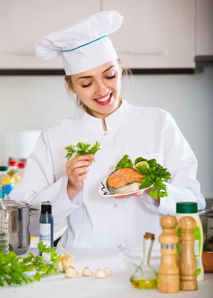 Happy young cook with prepared trout — Stock Photo, Image