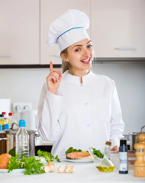 Cook with prepared trout in plate — Stock Photo, Image