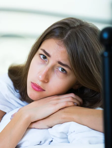 Portrait of sad teenage girl in home bed — Stock Photo, Image