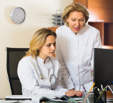 Two female doctors working together clipart