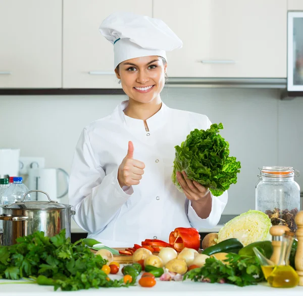 Woman in uniform at kitchen — Stock Photo, Image