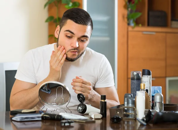 Man applying cream on face skin — Stock Photo, Image