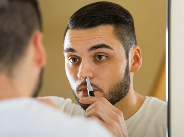 Guy remove hair from his nose — Stock Photo, Image