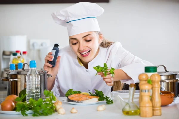 Young cook with prepared salmon — Stock Photo, Image