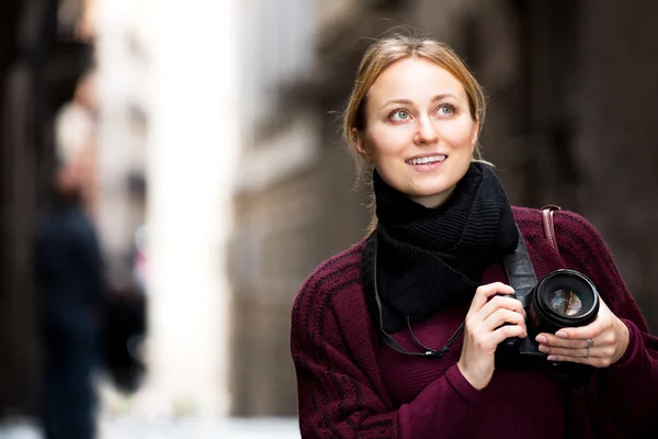 Girl holding camera in hands and photographing — Stock Photo, Image