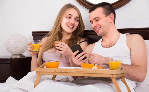 Couple with breakfast in bed — Stock Photo, Image