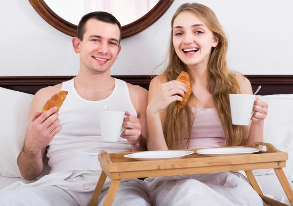 Adults posing with coffee and pastry for breakfast Royalty Free Stock Images