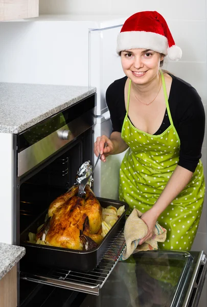 Housewife in Santa hat — Stock Photo, Image