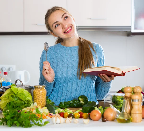 Νεαρή γυναίκα με βιβλίο συνταγών — Φωτογραφία Αρχείου