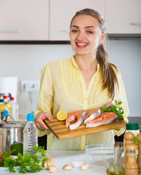 Woman with fish fillet — Stock Photo, Image