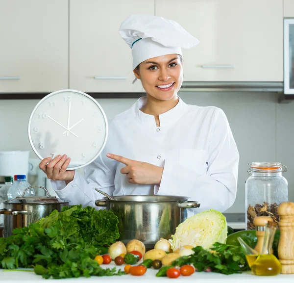 Femme avec horloge à la cuisine — Photo