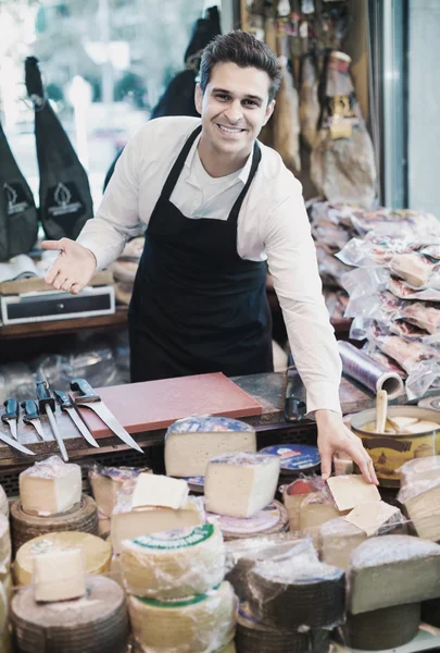 Salesman with cheese in gastronomy — Stock Photo, Image