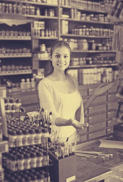 Female cashier standing in art shop — Stock Photo, Image