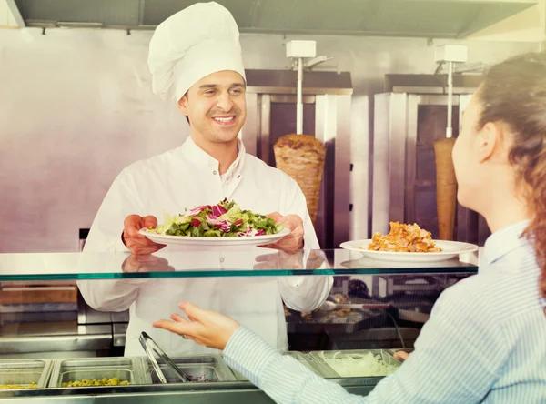Happy male worker serving customer — Stock Photo, Image
