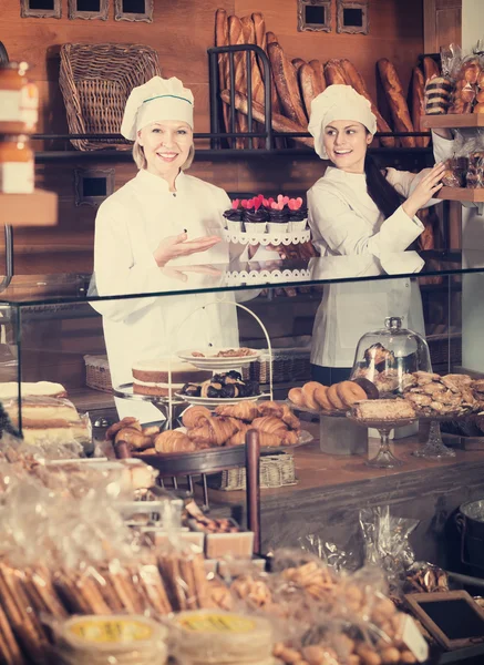 Cafe staff offering cakes — Stock Photo, Image