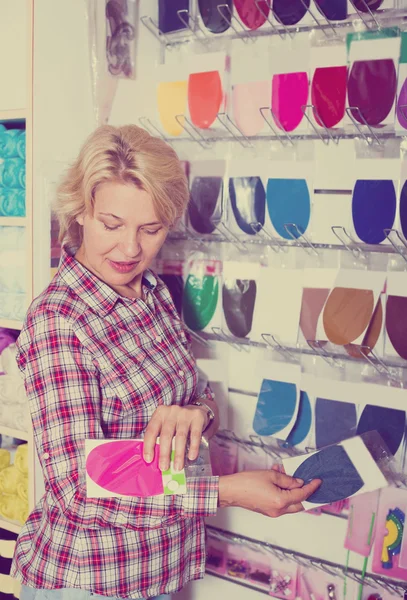 Woman buying decorative textile patch — Stock Photo, Image