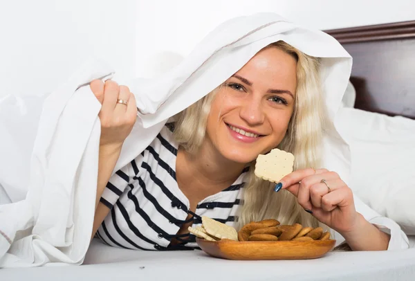 Female secretly eating biscuits — Stock Photo, Image