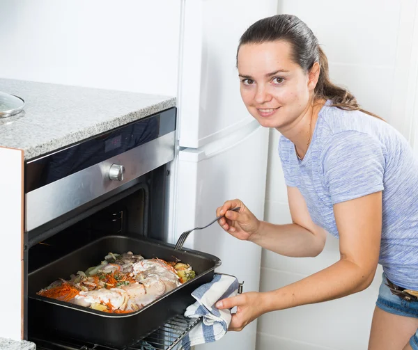 Žena připravuje maso pečené — Stock fotografie