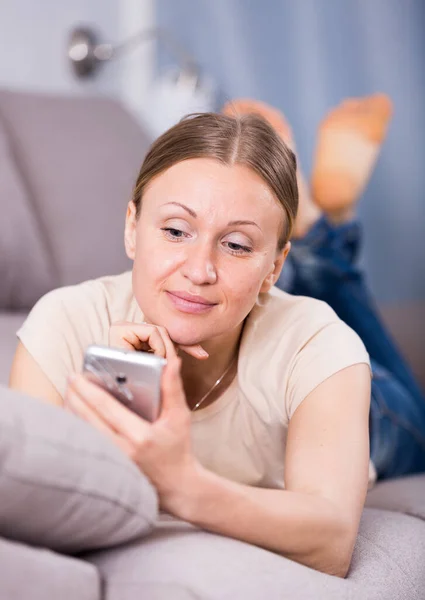 Mujer sonriente usando smartphone —  Fotos de Stock