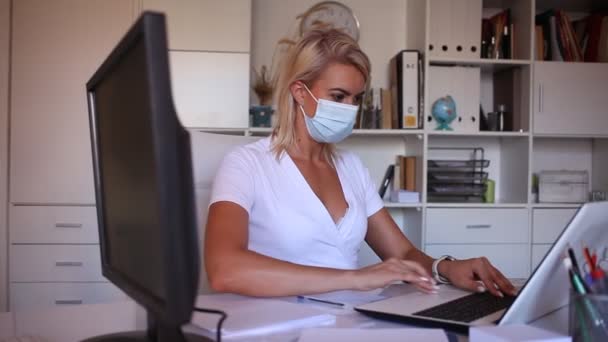 Female office worker in protective medical mask is standing with documents before signing it in office — Stock Video